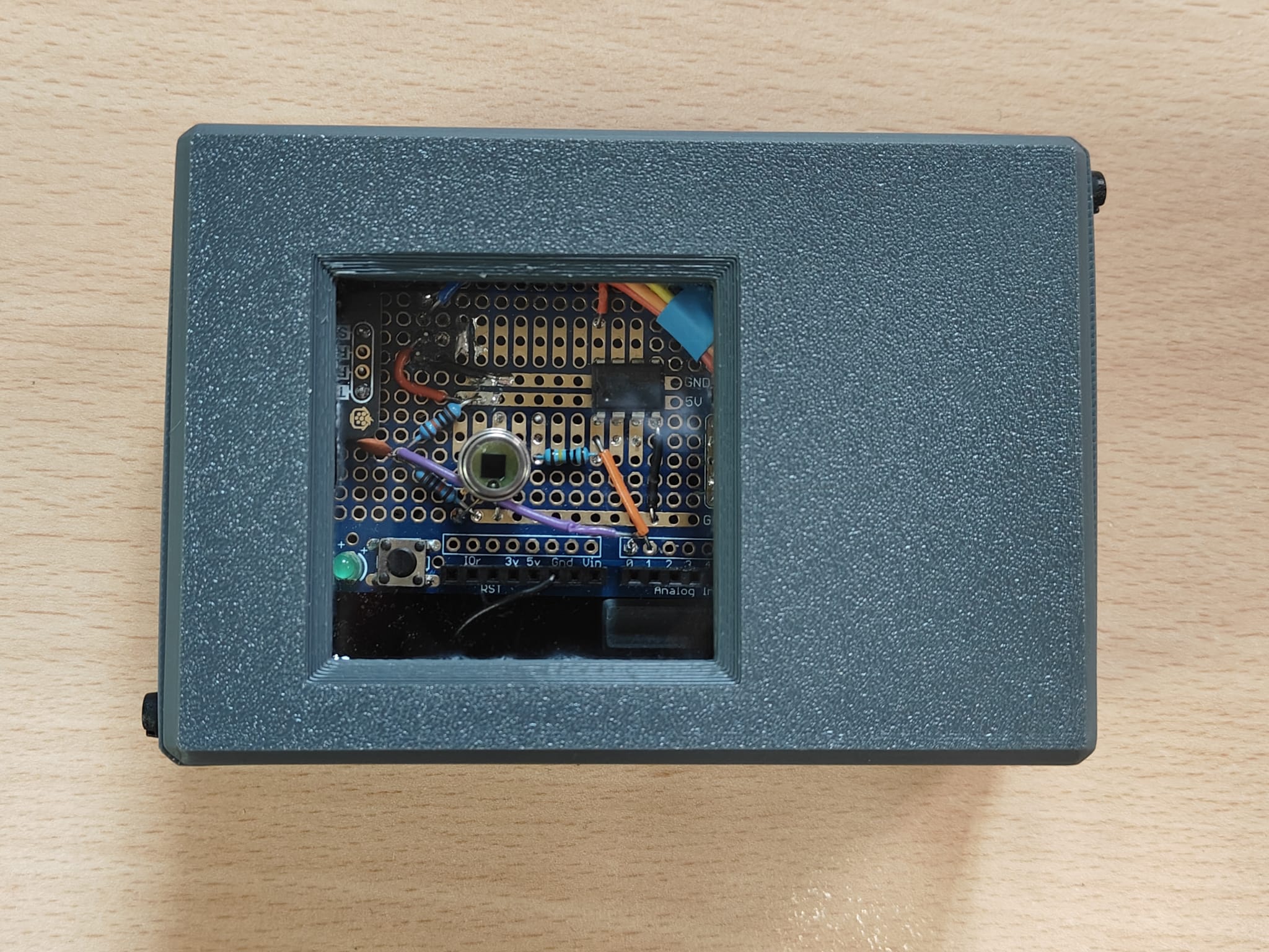 The ElectroTime device, seen from above: a compact 3D-printed enclosure with a window exposing the photodiode and circuit board inside